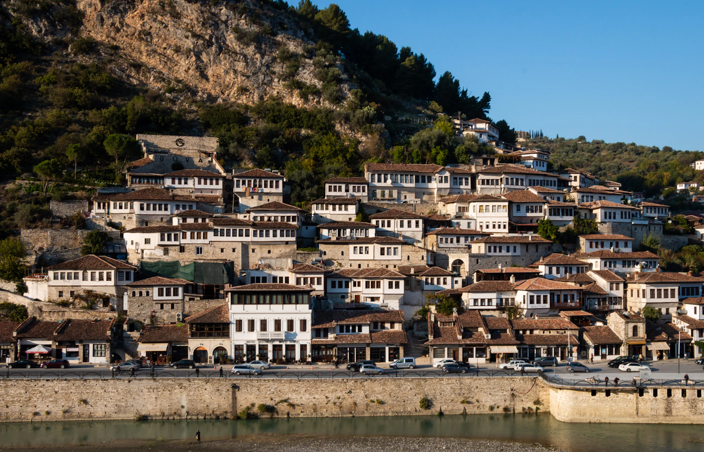 White Ottoman-era houses on the hillside above the Osum River in Berat, Albania