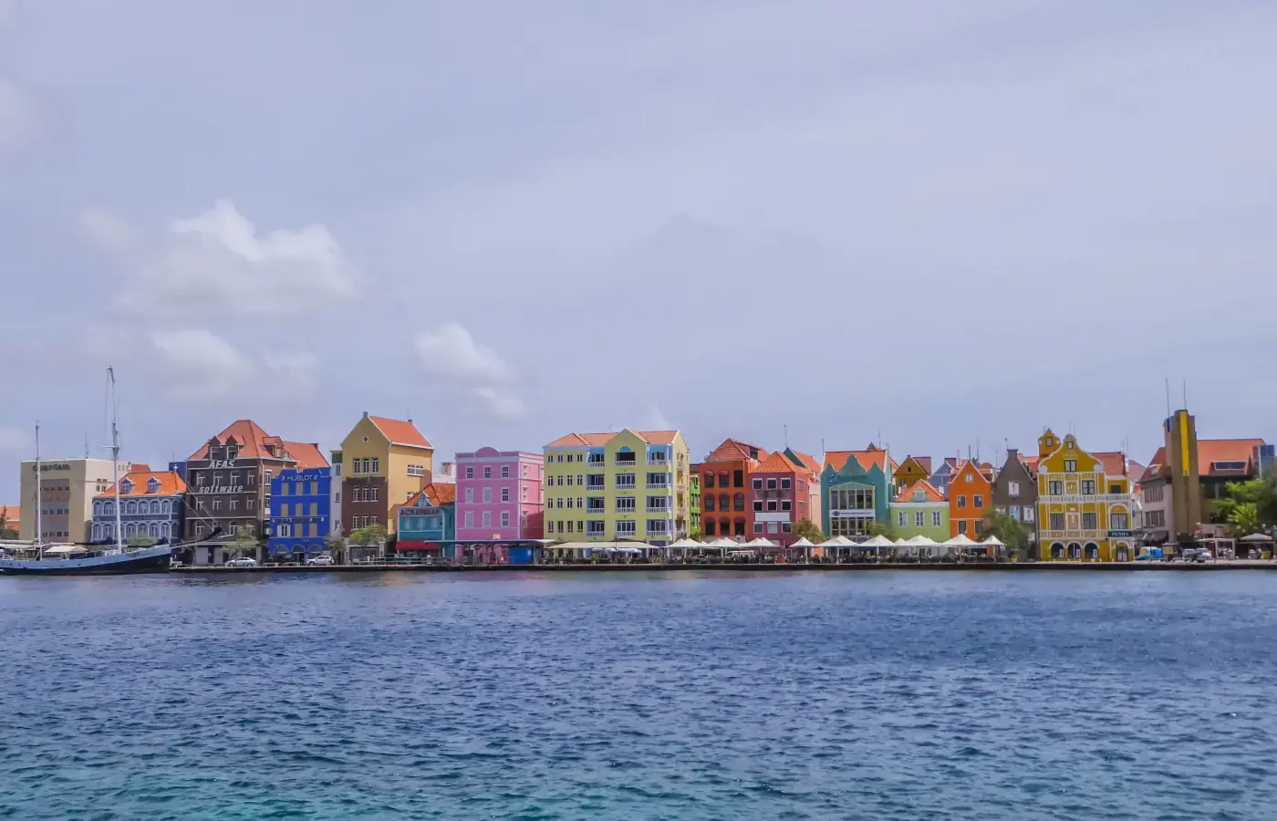 Colourful Handelskade waterfront buildings across the water in Willemstad, Curaçao