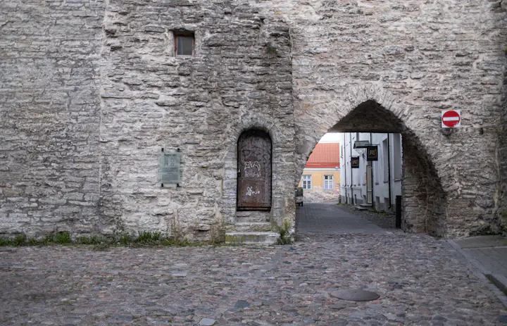 A stone archway and cobbled lane in Tallinn's old town