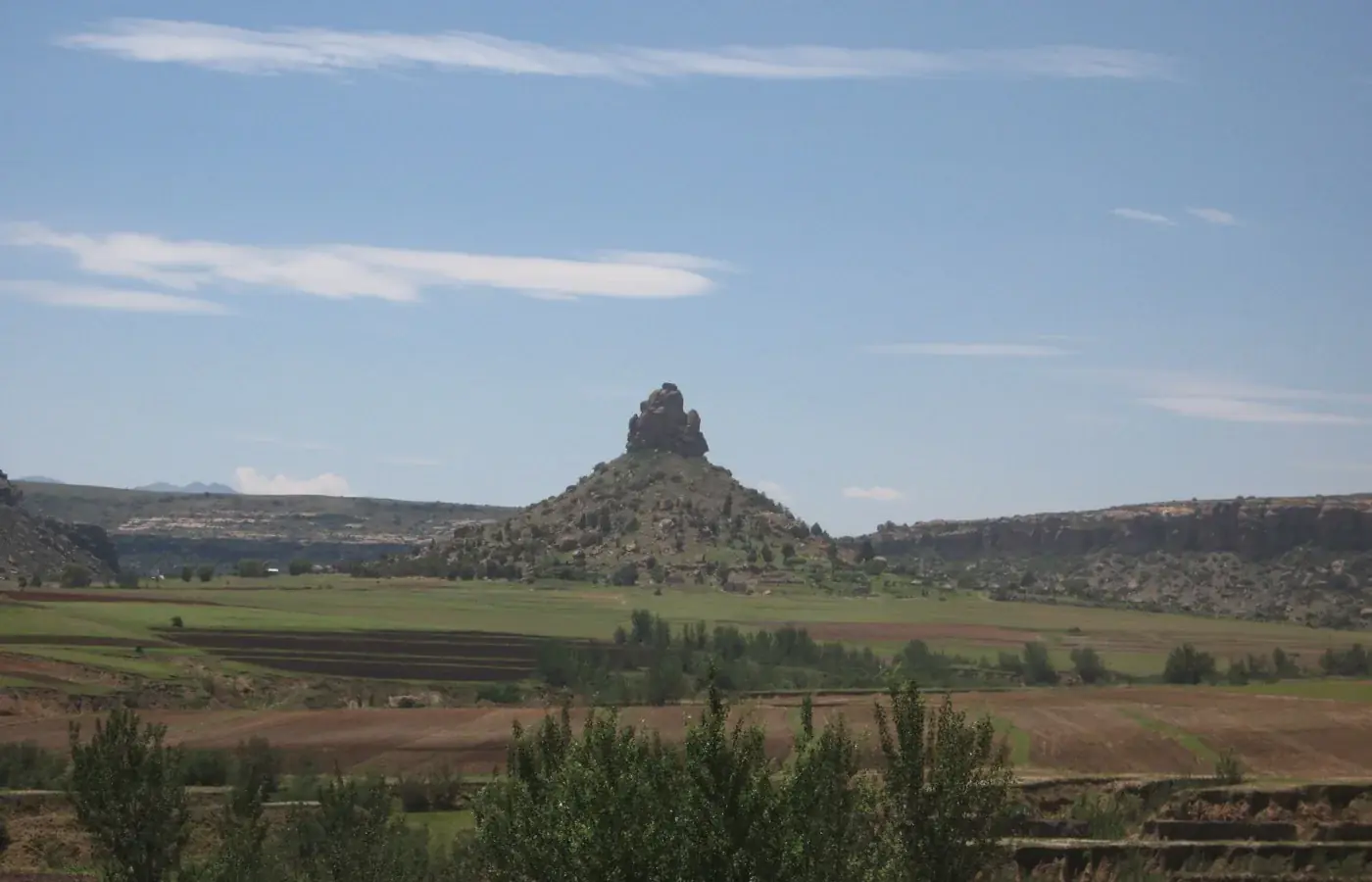 The rocky pinnacle of Qiloane and surrounding farmland near Thaba Bosiu in Lesotho