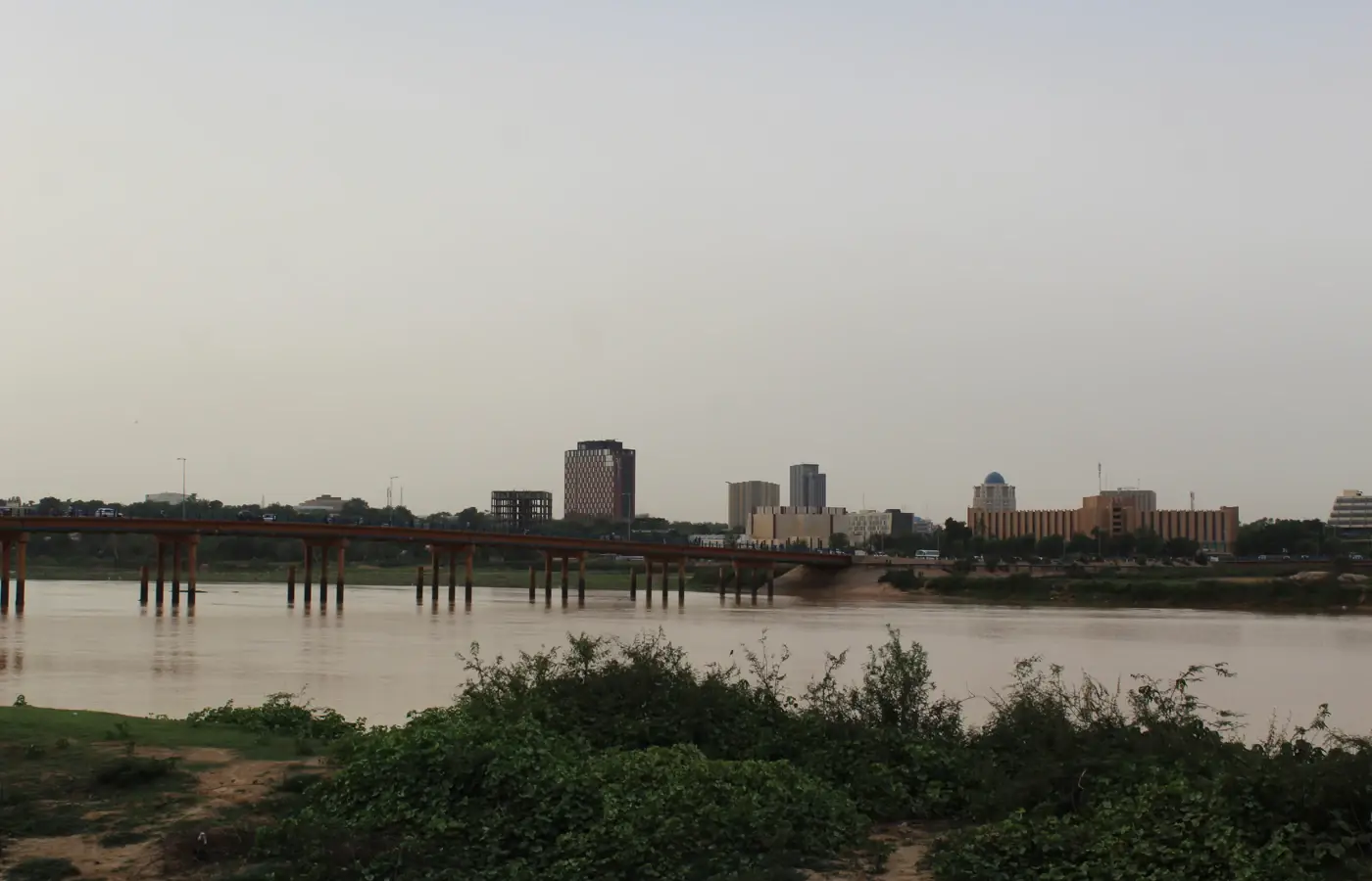 Niamey city buildings and the riverbank seen across the Niger River