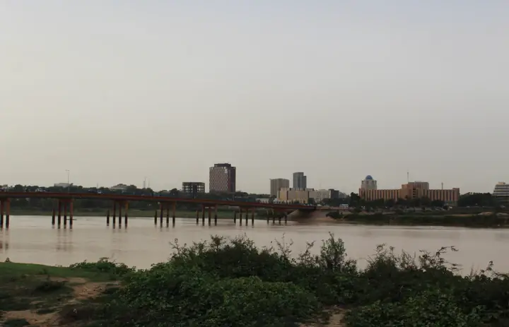 Niamey city buildings and the riverbank seen across the Niger River