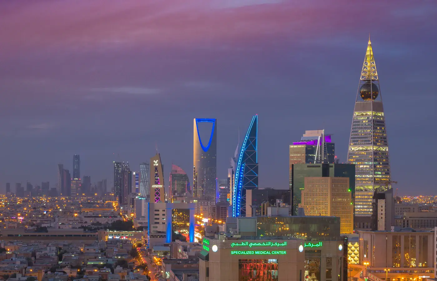 Riyadh skyline at dusk with the illuminated Kingdom Centre and Al Faisaliah Tower