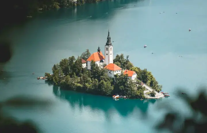 The island church and wooded shores of Lake Bled in Slovenia