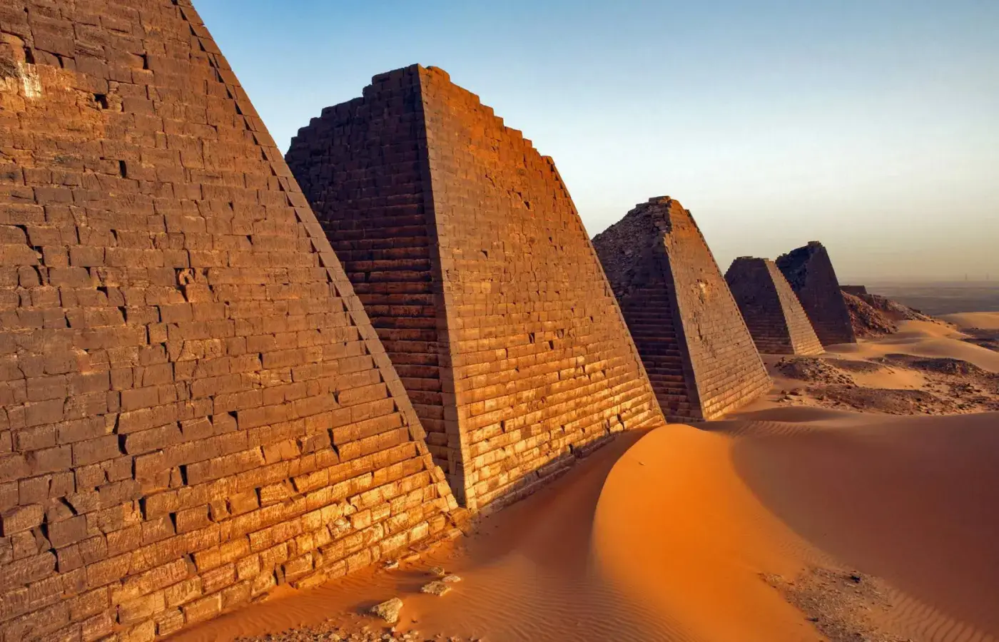 Steep stone pyramids and desert sand at Meroe in Sudan