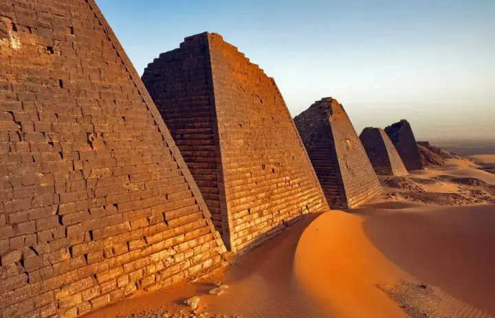 Steep stone pyramids and desert sand at Meroe in Sudan